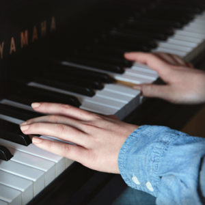 Playing piano at Eva Carlston Academy