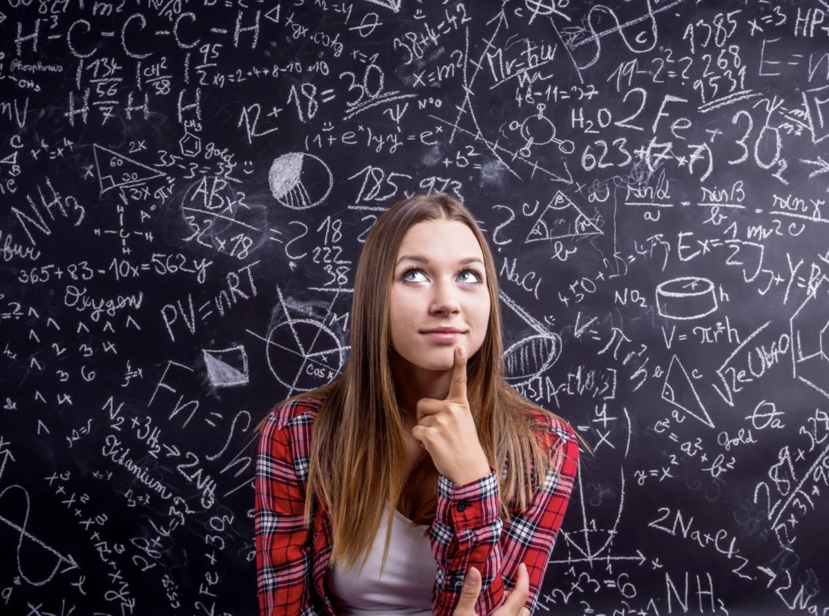 girl-thinking-in-front-of-chalkboard