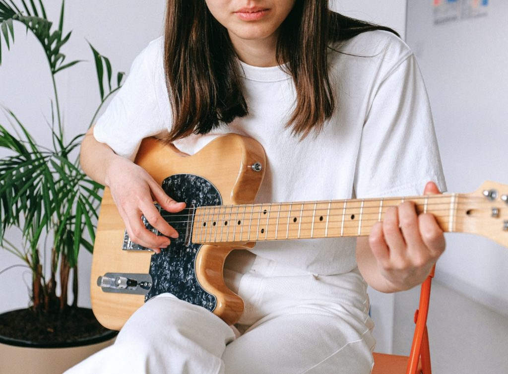 Eva Carlston Academy Girl playing guitar