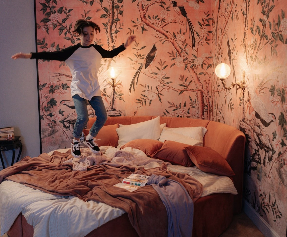 Kid jumping on bed
