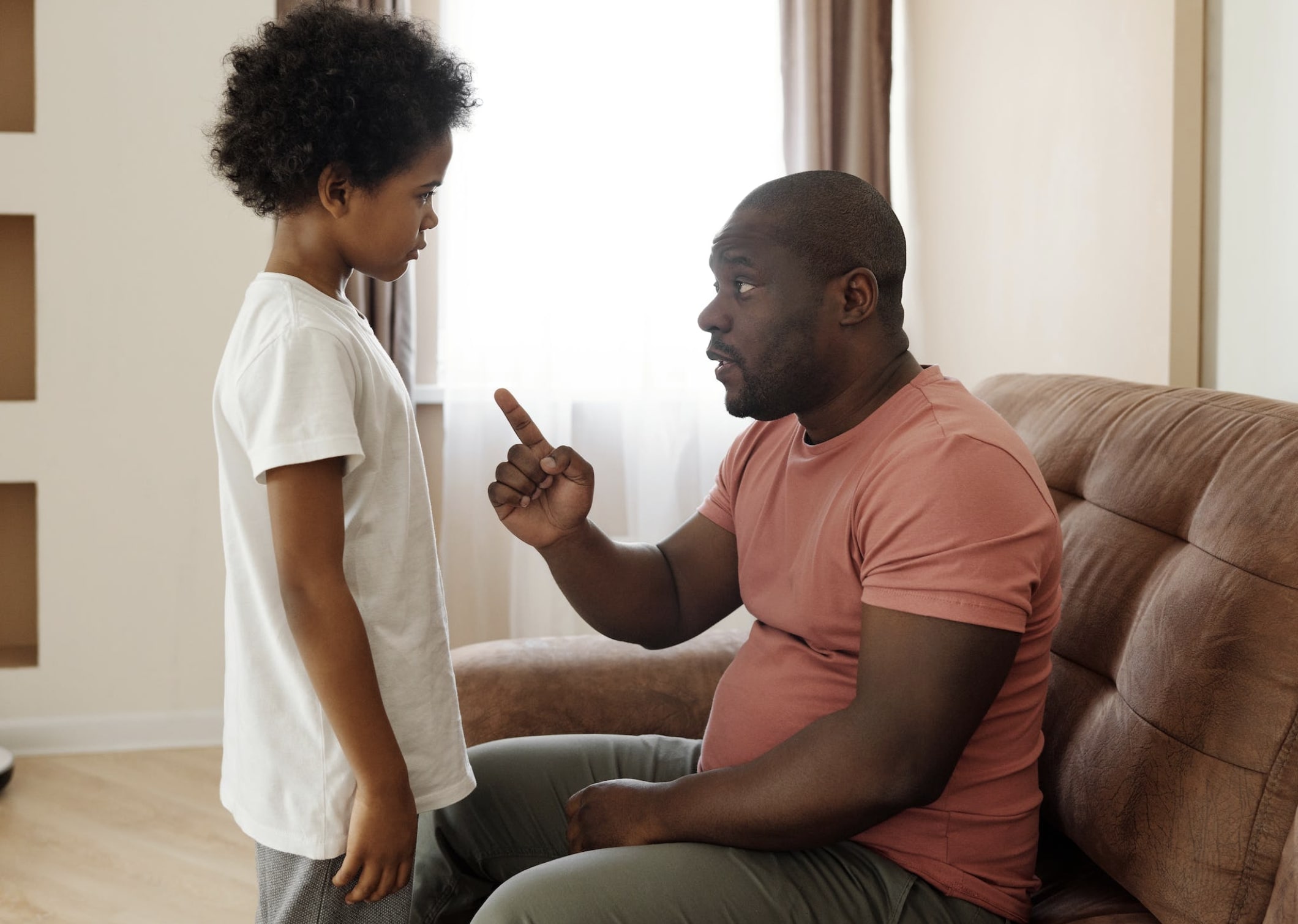 Man talking with child on couch