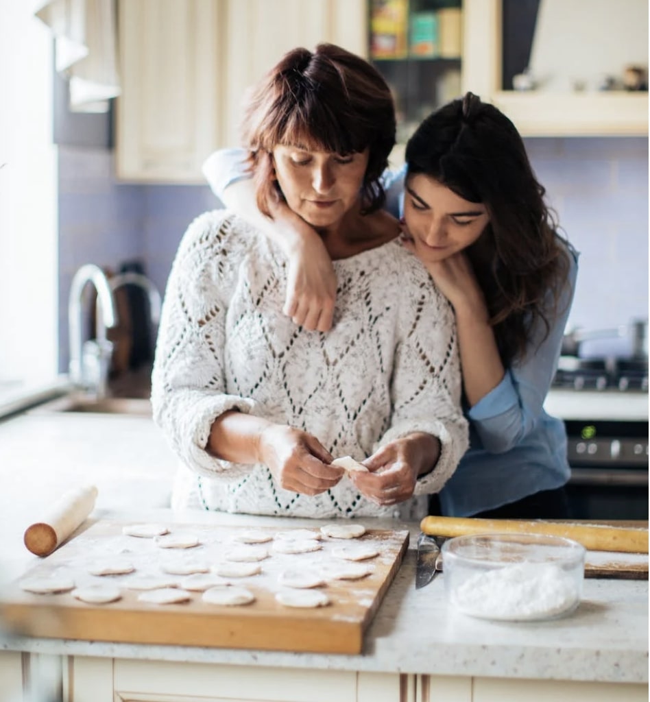 Mother and Teenager in Kitchen making food