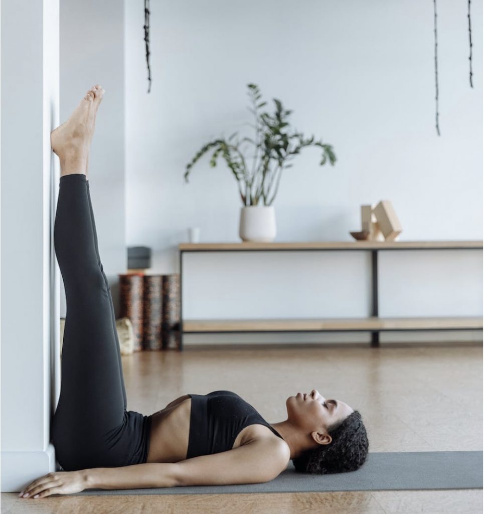 Woman doing L-shaped yoga stance
