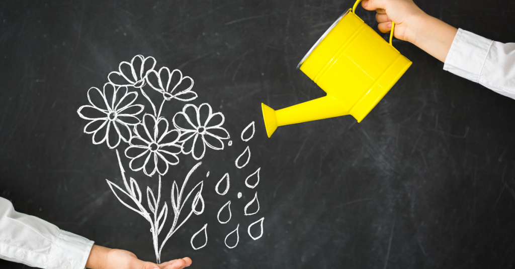 A yellow watering can being used to "water" a chalk drawing of flowers, symbolizing personal growth and self-reflection, with a focus on nurturing one’s inner development.