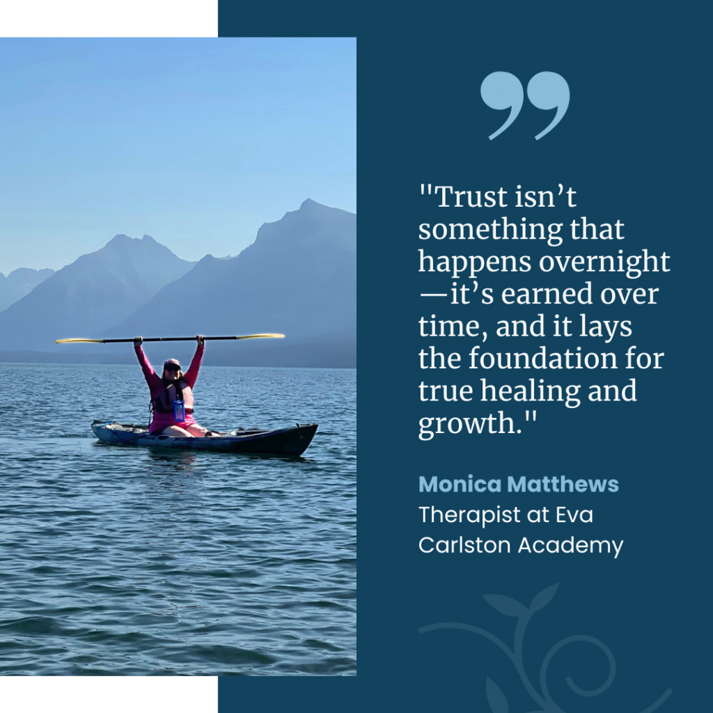 A photograph of Monica Matthews kayaking on a calm lake, lifting her paddle triumphantly, with mountains rising in the background. Her quote about trust, healing, and growth is displayed alongside her name and title as a therapist at Eva Carlston Academy.