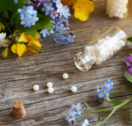 A glass bottle of pills spilled among flowers, representing misconceptions surrounding teen substance abuse and mental health myths.